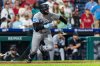 Miami Marlins' Liam Hicks runs to first after hitting an RBI single in the 10th inning of a baseball game against the Philadelphia Phillies, Tuesday, Sept. 23, 2025, in Philadelphia. (AP Photo/Laurence Kesterson)