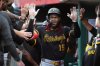 Pittsburgh Pirates' Oneil Cruz is congratulated in the dugout after hitting a two-run home run in the second inning of a baseball game against the Cincinnati Reds, Tuesday, Sept. 23, 2025, in Cincinnati. (AP Photo/Kareem Elgazzar)