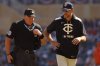 Minnesota Twins manager Rocco Baldelli speaks with home plate umpire Nick Mahrley, left, after a runner's interference call was awarded to the Cleveland Guardians on a play in the first inning of a baseball game Sunday, Sept. 21, 2025, in Minneapolis. (AP Photo/Bruce Kluckhohn)