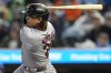 Cleveland Guardians' Bo Naylor (23) hits a two-RBI single against the Minnesota Twins in the first inning of a baseball game, Friday, Sept. 19, 2025, in Minneapolis. (AP Photo/Mike Stewart)
