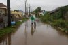A man wades through a flooded street ahead of the forecasted arrival of Hurricane Melissa in Old Harbour, Jamaica, Monday, Oct. 27, 2025. (AP Photo/Matias Delacroix)