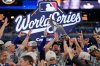 Los Angeles Dodgers pitcher Clayton Kershaw celebrates with the trophy after their win against the Toronto Blue Jays in Game 7 of baseball's World Series, Sunday, Nov. 2, 2025, in Toronto. (AP Photo/Brynn Anderson)