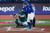 Toronto Blue Jays George Springer connects for a solo home run against the Seattle Mariners during the first inning in Game 1 of baseball's American League Championship Series, Sunday, Oct. 12, 2025, in Toronto. (AP Photo/David J. Phillip)