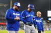 Toronto Blue Jays' George Springer (4) walks off the field as he leaves the game with an injury with manager John Schneider, left, and first assistant athletic trainer Voon Chong during seventh inning Game 3 World Series playoff MLB baseball action in Los Angeles on Monday, Oct. 27, 2025. THE CANADIAN PRESS/Frank Gunn
