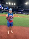 Toronto Blue Jay's Davis Schneider stands on the field barefooted before baseball World Series workouts, Thursday, Oct. 30, 2025, in Toronto. (AP Photo/Ronald Blum)