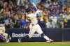 Milwaukee Brewers first baseman Andrew Vaughn (28) hits a solo home run against the Chicago Cubs during the fourth inning of Game 5 of baseball's National League Division Series, Saturday, Oct. 11, 2025, in Milwaukee. (AP Photo/Kayla Wolf)