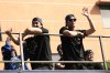Los Angels Dodgers' Shohei Ohtani, left, and Yoshinobu Yamamoto wave from a double-decker bus during a parade to celebrate the baseball team's World Series win on Monday, Nov. 3, 2025, in Los Angeles. (AP Photo/Jae C. Hong)