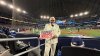 A Colonel Sanders impersonator sent by KFC Canada to promote their newly renamed sandwich, is seen in this handout photo, behind home plate at Game 2 of the World Series, in Toronto, on Saturday, Oct. 25, 2025. THE CANADIAN PRESS/Handout - KFC Canada (Mandatory Credit)
