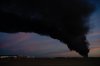 A plume of smoke wafts over airport property after reports of a plane crash at Louisville International Airport, Tuesday, Nov. 4, 2025, in Louisville, Ky. (AP Photo/Jon Cherry)