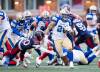 Winnipeg Blue Bombers&rsquo; Brady Oliveira (20) runs with the ball while defended by Montreal Alouettes&rsquo; Lorenzo Burns (20) during second half Eastern semi-final action, in Montreal on Saturday, Nov. 1, 2025. THE CANADIAN PRESS/Christopher Katsarov