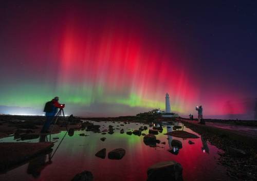 Owen Humphreys/ The Associated Press
                                The aurora borealis glow in the sky over St Mary&rsquo;s Lighthouse in Whitley Bay on the North East coast, England.