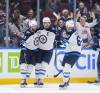 Darryl Dyck / THE CANADIAN PRESS
                                Adam Lowry (centre) celebrates a Jets goal against the Vancouver Canucks with Alex Iafallo (left) and Nino Niederreiter. &lsquo;I picture myself as a Winnipeg Jet for life,&rsquo; the team&rsquo;s captain said last spring.