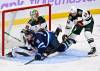 Minnesota Wild Zach Bogosian (24) dumps Winnipeg Jets&rsquo; Jonathan Toews (19) in front of his goaltender Jesper Wallstedt (30) during first period of Sunday&rsquo;s game. (Fred Greenslade / The Canadian Press)