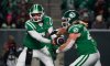 Saskatchewan Roughriders quarterback Trevor Harris hands off the football to running back A.J. Ouellette during the first half of the CFL West Final in Regina on Nov. 8, 2025. THE CANADIAN PRESS/Heywood Yu