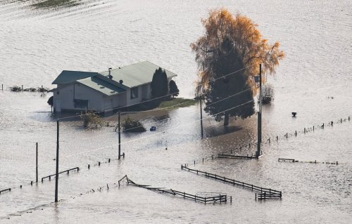 A house on a farm is surrounded by floodwaters in Abbotsford, B.C., on Wednesday, November 17, 2021. THE CANADIAN PRESS/Darryl Dyck