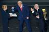 Alex Brandon / THE ASSOCIATED PRESS
                                U.S. President Donald Trump (centre) placed the inaugural FIFA Peace Prize medal on himself in Napoleonesque fashion Friday that FIFA President Gianni Infantino (right) had awarded him at the 2026 World Cup Group Stage Draw alongside the macabre inaugural trophy.