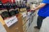 MIKE DEAL / FREE PRESS
                                A Liquor Mart employee puts the final touches on a display of U.S. liquor about to go on sale at the Crestview store Wednesday morning.
