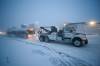 A city tow truck hauls away a bus after it was in a collision with another bus on Ellice Avenue at Empress Street during morning rush hour in the middle of a blizzard. (Mike Deal / Free Press)