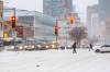 MIKE DEAL / FREE PRESS
                                Pedestrians and vehicles at Portage Avenue and SherbrookThursday morning during the season&rsquo;s first major blizzard. Outreach agencies have been working to shelter people in the inclement weather.