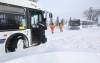 Ruth Bonneville / Free Press
                                A city of Winnipeg tow truck driver does a wellness check on two transit drivers after they were stuck for hours in snow drifts on Victoria Ave. east near Redonda in Transcona Thursday morning. The transit drivers had had already been in their busses for 7 hours waiting for a tow truck.