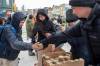BROOK JONES/FREE PRESS
                                Volunteers Imtiaz Sidhu, Karen Kiss, and her son Miguel Kiss hand out soup and sandwiches to a person in need along Main Street near Logan Avenue on Christmas Day. They were among about 50 volunteers who participated in a community walk organized by OPK.