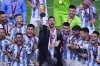 FILE — Argentina's Lionel Messi holds the trophy aloft as he celebrates with his team at the end of the World Cup final soccer match between Argentina and France at the Lusail Stadium in Lusail, Qatar, Sunday, Dec. 18, 2022. (AP Photo/Hassan Ammar, File)