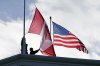 FILE - Washington State Park workers put up a new Canadian flag in front of an American flag about to be replaced during scheduled maintenance atop the Peace Arch in Peace Arch Historical State Park Monday, Nov. 8, 2021, in Blaine, Wash.   (AP Photo/Elaine Thompson, File)