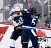 St. Louis Blues' Brayden Schenn (10) is checked by Winnipeg Jets' Luke Schenn (5) during first period NHL playoff action in Winnipeg, Monday April 21, 2025. THE CANADIAN PRESS/Fred Greenslade
