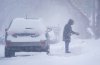 A person shovels snow in Saskatoon, Monday, Feb. 26, 2024. Environment Canada has issued a Blizzard Warning for Saskatoon as an Alberta clipper tracks across the Prairies. THE CANADIAN PRESS/Heywood Yu