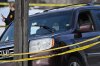 A bullet hole is seen in the windshield as law enforcement officers attend to the scene of the shooting involving federal law enforcement agents, Wednesday, Jan. 7, 2026, in Minneapolis. (AP Photo/Tom Baker)