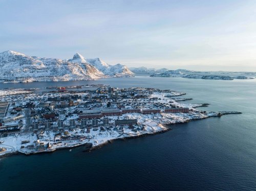 Houses are seen near the coast of a sea inlet of Nuuk, Greenland, on Sunday, Jan. 25, 2026. (AP Photo/Evgeniy Maloletka)