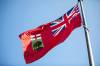 MIKAELA MACKENZIE / WINNIPEG FREE PRESS 	 The Manitoba flag flies in front of the Manitoba Legislative Building on Monday, Aug. 19, 2024. According to a Probe Research poll, 49% of Manitobans would support creating a new flag for the province. Winnipeg Free Press 2024