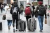 Travellers wheel and carry their luggage through Trudeau airport in Montreal, Friday, Jan. 3, 2025. THE CANADIAN PRESS/Graham Hughes.