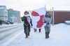 Iqaluit residents Laakkuluk Williamson Bathory and Siku Rojas hold a Greenlandic banner during a solidarity march through Nunavut’s capital on Saturday, Jan. 17, 2026. THE CANADIAN PRESS/Dustin Patar