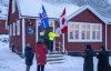 Flags are checked and temporarily raised before the opening of the Canadian consulate in Nuuk, Greenland, on Thursday, Feb. 5, 2026. THE CANADIAN PRESS/Christinne Muschi