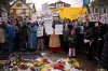 Protesters react as they visit a makeshift memorial during a rally for Renee Good, who was fatally shot by an ICE officer earlier in the week, Saturday, Jan. 10, 2026, in Minneapolis. (AP Photo/John Locher)