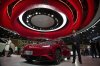 A worker stands near the latest car from Chinese luxury car brand Hongqi during the Shanghai auto show on Thursday, April 24, 2025. (AP Photo/Ng Han Guan)