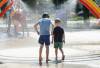 RUTH BONNEVILLE / FREE PRESS FILES
                                Local weather standup Thomas Smith-Windsor (6yrs), races through the spray of the rainbow at Provencher Spray Pad on his way home from his last day of school Tuesday. Even though Thomas was in school remotely these past months, students were allowed to return to class for their last day of school to drop off supplies and pick up their personal items, His dad, Alex, offered to treat him on the exceptionally hot day, with a stop at the spray pad with his little brother Simon (3yrs). JUNE 29, 2021