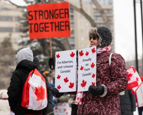 Lisa Budney holds a protest sign as people take part in a pro-Canada anti-separatist rally in Edmonton on Saturday, Feb. 21, 2026. THE CANADIAN PRESS/Ryan Jackson