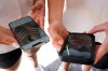 FILE - Young people use their phones to view social media in Sydney, Nov. 8, 2024. (AP Photo/Rick Rycroft, File)