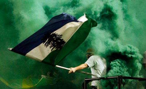 A Portland Timbers fan is inundated with green smoke as he celebrates a second half goal during their MLS soccer game against the San Jose EarthquakeTuesday, July 3, 2012, in Portland, Ore. THE CANADIAN PRESS/AP, Don Ryan