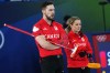 Canada's Brett Gallant, left, and Jocelyn Peterman compete during the mixed doubles round robin phase of the curling competition against Estonia at the 2026 Winter Olympics, in Cortina d'Ampezzo, Italy, Saturday, Feb. 7, 2026. (AP Photo/Fatima Shbair)