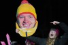 A person holds a giant portrait of Germany's Max Langenhan in the finish area during a men's single luge run at the 2026 Winter Olympics, in Cortina d'Ampezzo, Italy, Sunday, Feb. 8, 2026. (AP Photo/Alessandra Tarantino)