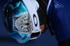 A wolf is displayed on the helmet of Austria's Claudia Riegler as she waits to compete during the women's snowboarding parallel giant slalom qualifications at the 2026 Winter Olympics, in Livigno, Italy, Sunday, Feb. 8, 2026. (AP Photo/Gregory Bull)