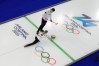 Canada's Brett Gallant and Jocelyn Peterman compete against Switzerland during a curling mixed doubles session at the 2026 Winter Olympics in Cortina d'Ampezzo, Italy on Feb. 9, 2026. (AP Photo/David J. Phillip)