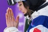 China's Eileen Gu celebrates after her score during the women's freestyle skiing slopestyle finals at the 2026 Winter Olympics, in Livigno, Italy, Monday, Feb. 9, 2026. (AP Photo/Gregory Bull)