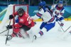 Emily Clark (26) of Team Canada tries a wrap-around as Laila Edwards (10) of Team United States defends during third period Olympic hockey action at the 2026 Milan Cortina Winter Olympics in Milan, Italy on Tuesday, Feb. 10, 2026. THE CANADIAN PRESS/Nathan Denette