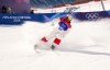 Elliot Vaillancourt from Drummondville, Que., slides into the finish zone as he competes in the men's moguls qualification two at the Milano Cortina 2026 Winter Olympic Games in Livigno, Italy on Thursday, Feb. 12, 2026. THE CANADIAN PRESS/Sean Kilpatrick