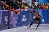 Jens van 't Wout of the Netherlands slaps hands with a coach after winning gold during the short track speed skating men's 1000m at the 2026 Winter Olympics, in Milan, Italy, Thursday, Feb. 12, 2026. (AP Photo/Ashley Landis)