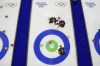 Canada's Ben Hebert, Marc Kennedy and Brad Jacobs compete during a men's curling round robin session against Germany at the 2026 Winter Olympics, in Cortina d'Ampezzo, Italy, Wednesday, Feb. 11, 2026. (AP Photo/David J. Phillip)